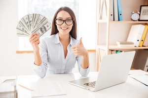graphicstock-image-of-businesswoman-dressed-in-white-shirt-sitting-in-her-office-and-holding-money-in-hand-while-making-thumbs-up-gesture_SI3lOtY7uhg_thumb