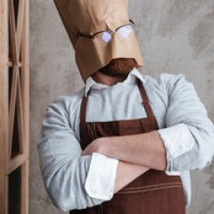 graphicstock-picture-of-young-man-baker-standing-with-paper-bag-on-head-wearing-glasses-at-bakery-near-bread_HdZT-ctpl_thumb