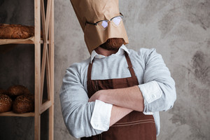 graphicstock-picture-of-young-man-baker-standing-with-paper-bag-on-head-wearing-glasses-at-bakery-near-bread_HdZT-ctpl_thumb